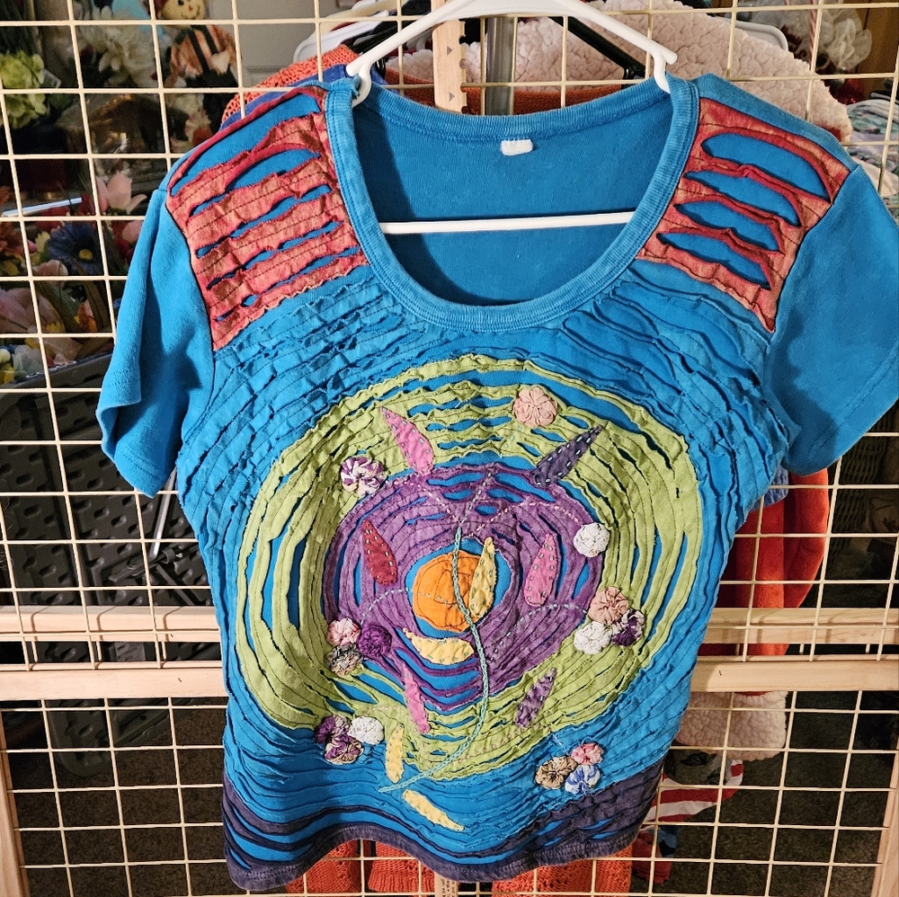 This is a very colorful shirt. PRELOVED No tag for the size fits like a large.